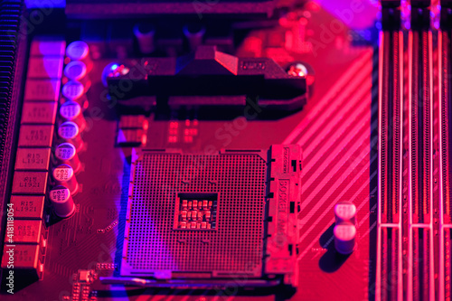 Blurred background. Socket am4. Close up of the AM4 socket for the motherboard with neon blue and red lights. Technological background photo