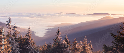 Fog in the mountain valley, view from the Snieznik peak at sunset.