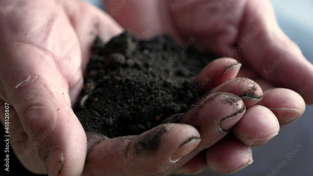 Close-up of a farmer holding the earth in his hands. Clean ecological land for plant cultivation theme. Working hands hold the soil. Love for the earth. Selective focus, shallow depth of field Close-up of a farmer holding the earth in his hands. Clean ecological land for plant cultivation theme. Working hands hold the soil. Love for the earth. Selective focus, shallow depth of field