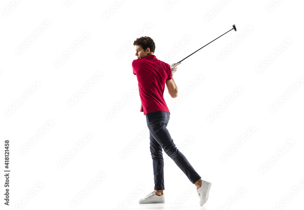 Golf player in a red shirt taking a swing isolated on white studio background with copyspace. Professional player practicing confident, emotions and facial expression. Sport, motion, action concept.