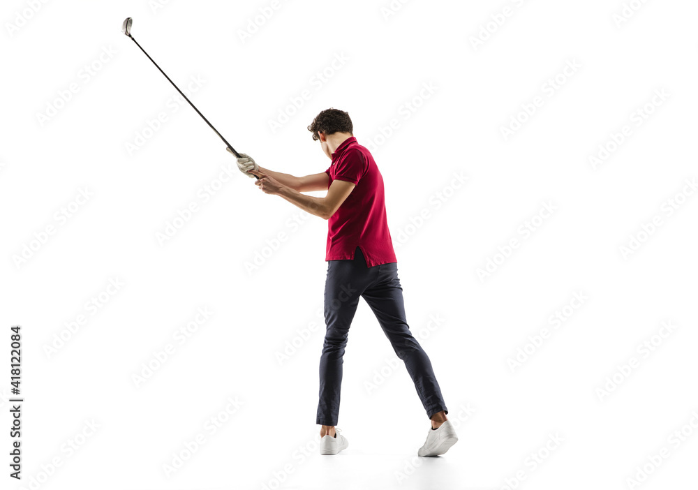 Obraz premium Golf player in a red shirt taking a swing isolated on white studio background with copyspace. Professional player practicing confident, emotions and facial expression. Sport, motion, action concept.
