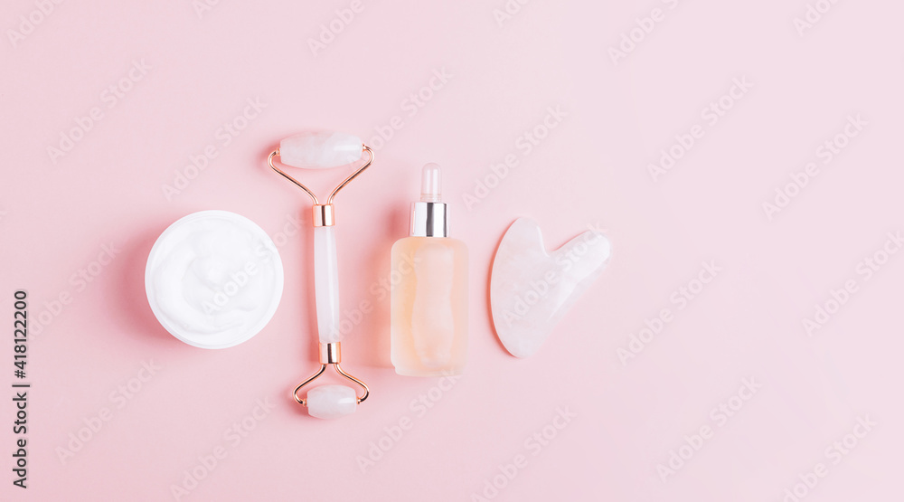 Facial massage set roller scraper guasha pink background. Facial massage set roller scraper guasha pink background.