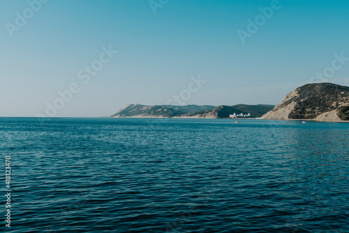 Black sea coast. Blue Bay Krasnodar Territory. Summer vacation in Russia. Mountains, sea, blue sky.