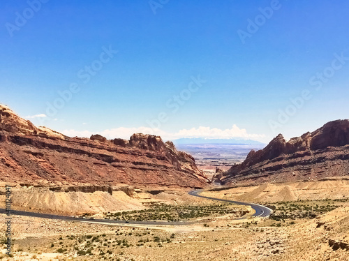 The winding road going through a deserted highway in the southwest US.