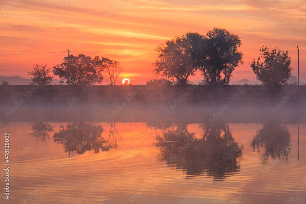 Bright foggy dawn on the misty lake Bright foggy dawn on the misty lake
