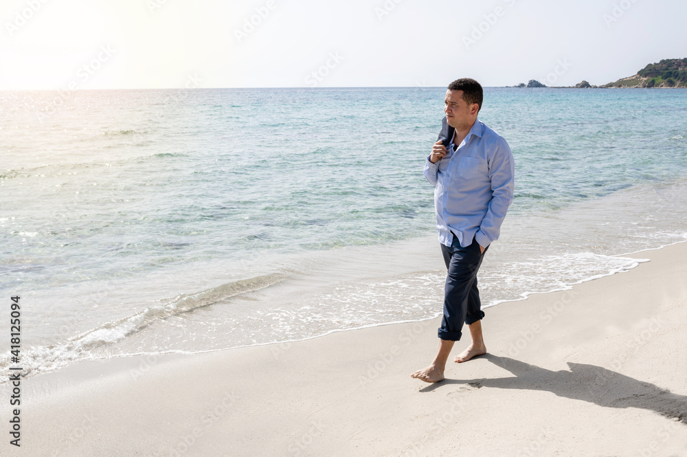 Latin businessman with suit take off jacket with barefoot walking on the shore in beautiful beach. Relaxing after hard work. Latin businessman with suit take off jacket with barefoot walking on the shore in beautiful beach. Relaxing after hard work.