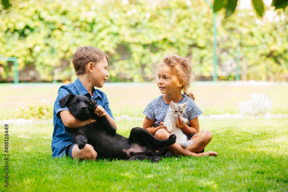 Fototapeta premium Cheerful brother and sister happily chatting in park
