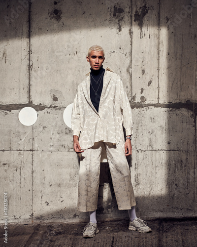 male fashion model posing in a concrete city carpark 