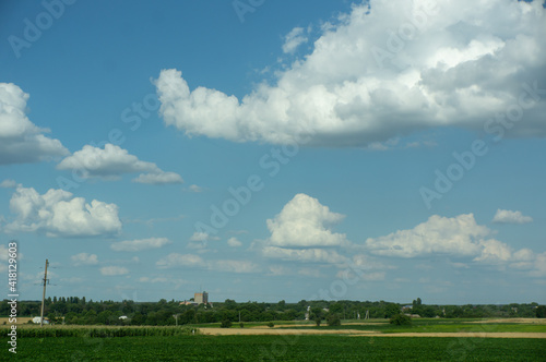 field landscape and blue sky with white clouds © Vitaly