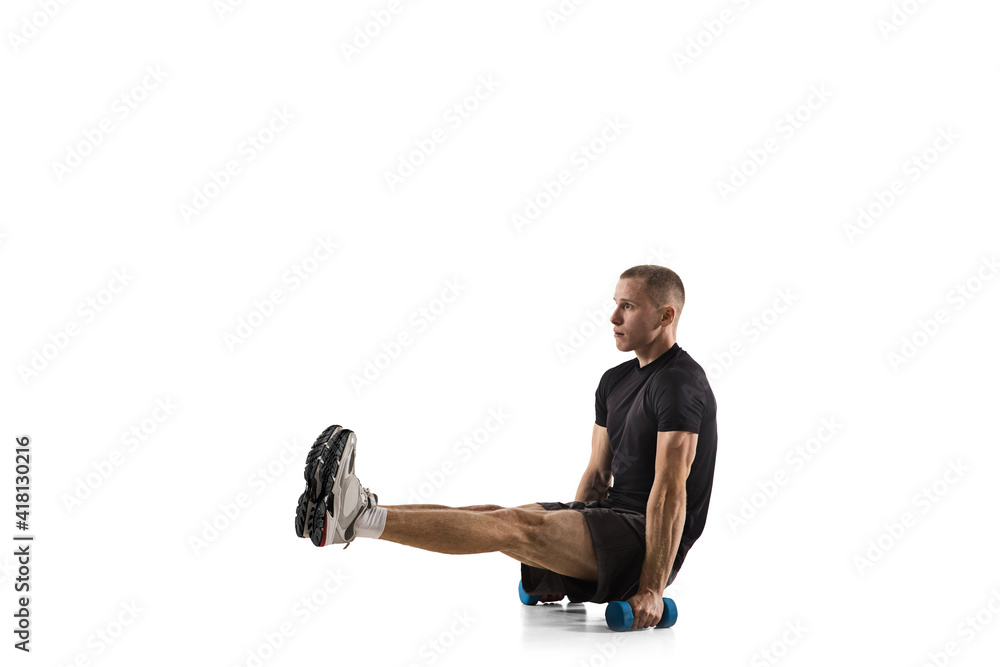 Dumbbells. Young caucasian male model in action, motion isolated on white background with copyspace. Concept of sport, movement, energy and dynamic, healthy lifestyle. Training, practicing. Authentic. Dumbbells. Young caucasian male model in action, motion isolated on white background with copyspace. Concept of sport, movement, energy and dynamic, healthy lifestyle. Training, practicing. Authentic.