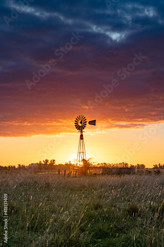 Windmill in the sunset, at the fields of Buenos Aires, Argentina