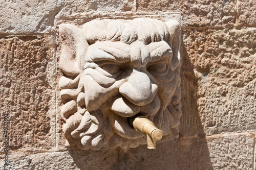 Gothic stone head of Fontain of the Church in Solsona, Lleida,Catalonia, Spain. photo