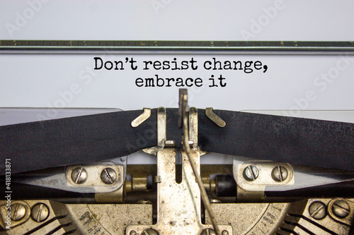 Time to change symbol. Text Do not resist change embrace it typed on retro typewriter. Business and time to change concept. Beautiful background. Copy space. photo