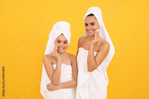 beauty day in spa. family spa. mother and teen girl use cotton pads. skincare. taking off makeup.