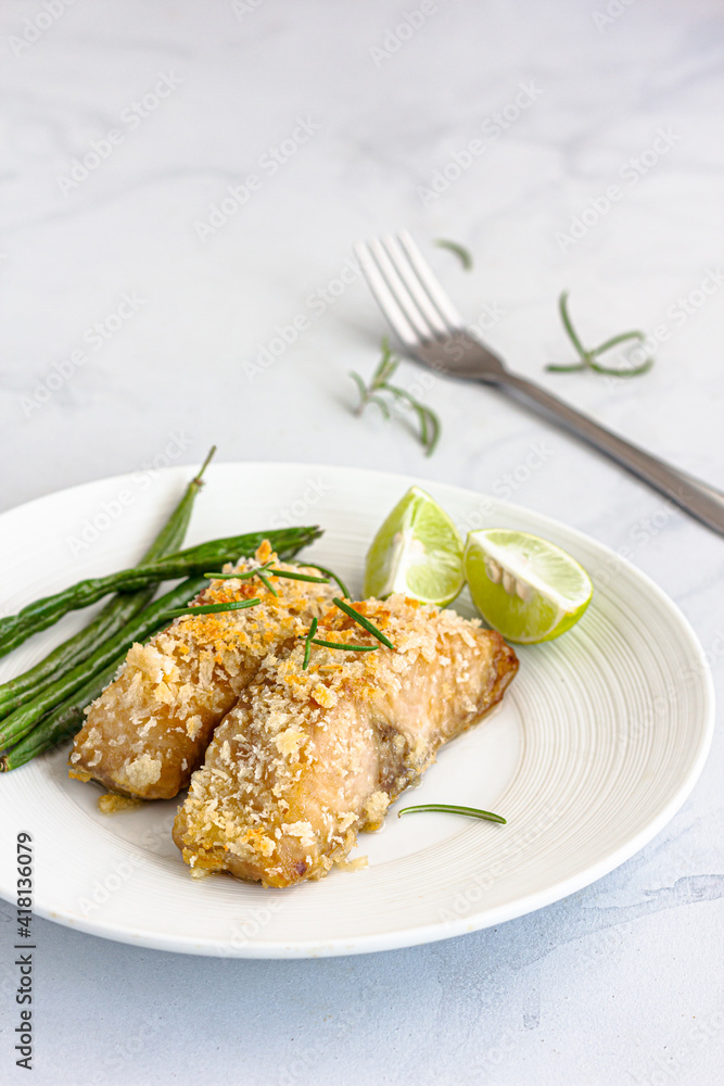 Baked Fish with Beans and Lemon GArnished with Rosemary Leaves Vertical Photo Baked Fish with Beans and Lemon GArnished with Rosemary Leaves Vertical Photo