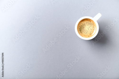 Cup of coffee on gray  background. Top view. Copy space. 