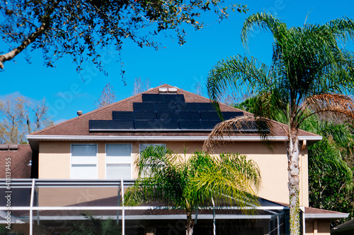 Solar panel on a house roof; Green energy from sun	 photo