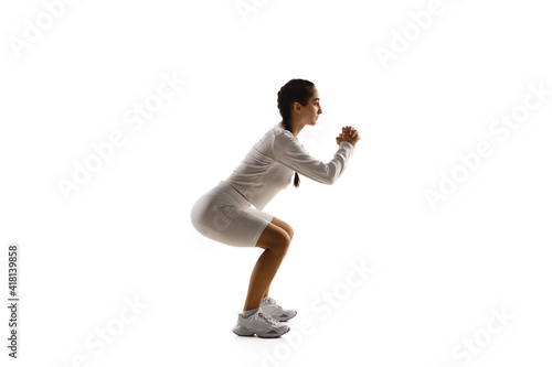 Work out. Young caucasian female model in action, motion isolated on white background with copyspace. Concept of sport, movement, energy and dynamic, healthy lifestyle. Training, practicing.