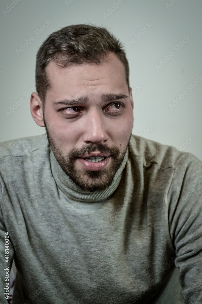 Portrait of a sad young bearded man who is crying Portrait of a sad young bearded man who is crying