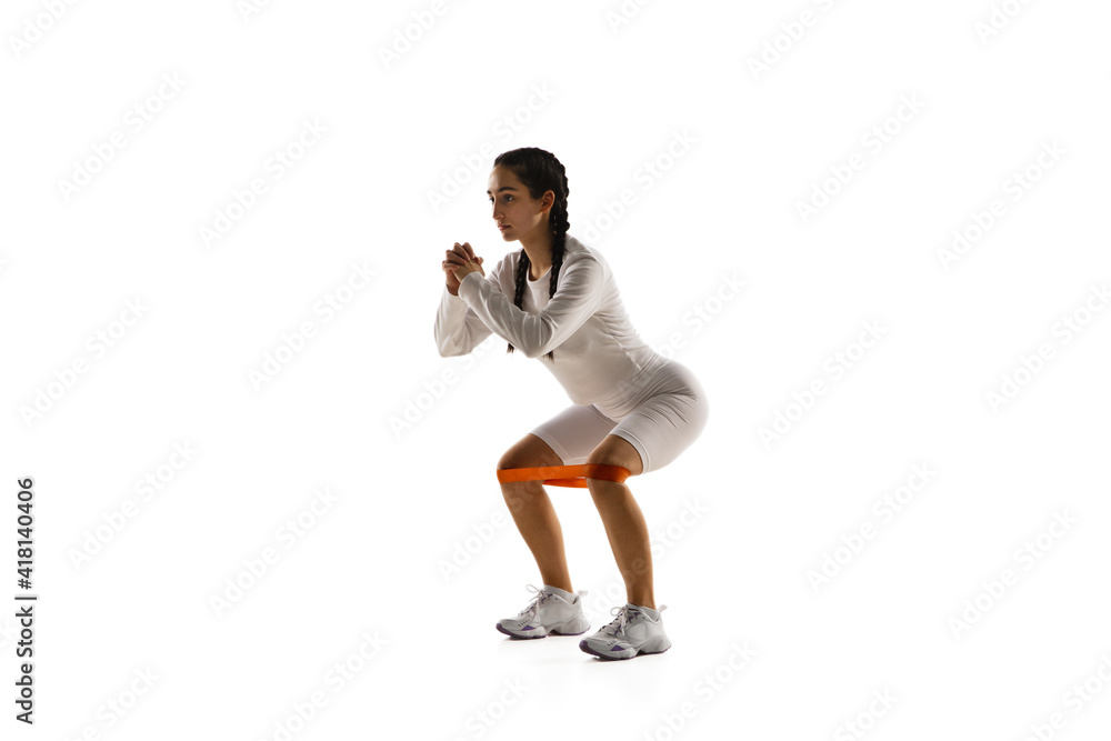 Work out. Young caucasian female model in action, motion isolated on white background with copyspace. Concept of sport, movement, energy and dynamic, healthy lifestyle. Training, practicing. Work out. Young caucasian female model in action, motion isolated on white background with copyspace. Concept of sport, movement, energy and dynamic, healthy lifestyle. Training, practicing.