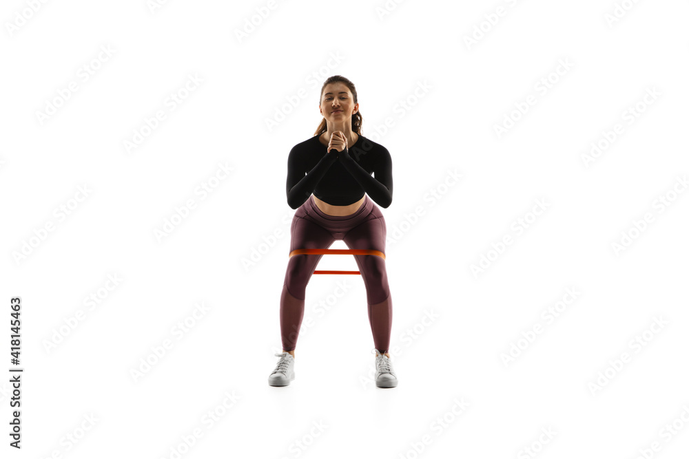 Strong. Young caucasian female model in action, motion isolated on white background with copyspace. Concept of sport, movement, energy and dynamic, healthy lifestyle. Training, practicing. Strong. Young caucasian female model in action, motion isolated on white background with copyspace. Concept of sport, movement, energy and dynamic, healthy lifestyle. Training, practicing.
