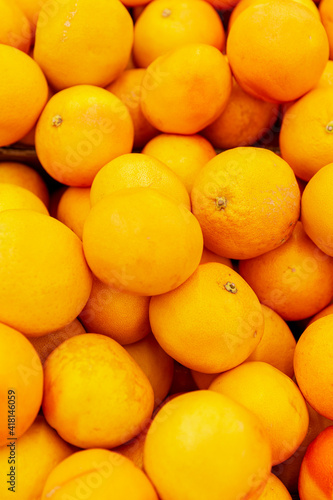 A bunch of bright juicy oranges. Healthy food and vitamins. Vertical.