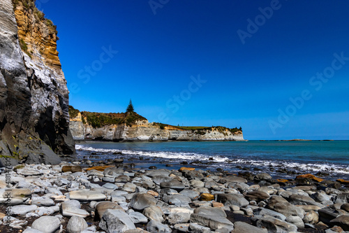 Black sand and stone beach in New Zealand during daylight photo