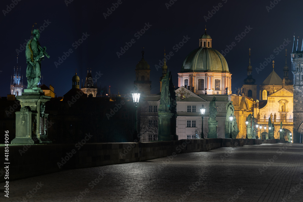 lights on the Charles Bridge on the Vltava river at night and in the background the bridge tower lights on the Charles Bridge on the Vltava river at night and in the background the bridge tower