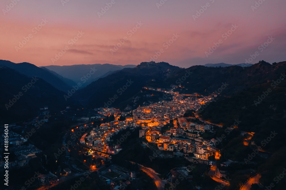Aerial view of city of Mammola at night. Calabria, Italy