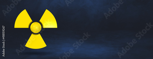 Fotografia Radioactive symbol on a dark blue studio background banner