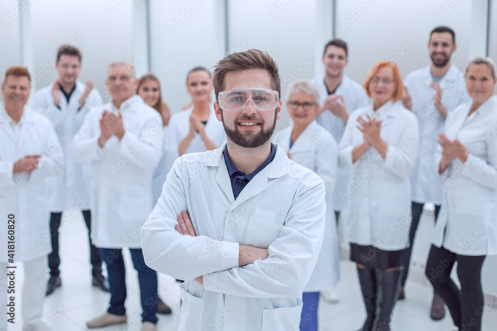 confident scientific leader standing in front of a team of young scientists. confident scientific leader standing in front of a team of young scientists.