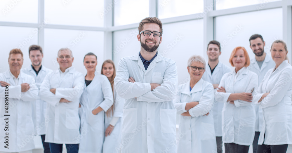 confident scientific leader standing in front of a team of young scientists. confident scientific leader standing in front of a team of young scientists.