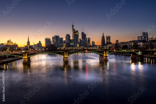 The skyline of Frankfurt at sunset  seen from a bridge at the river Main at a cold day in winter.