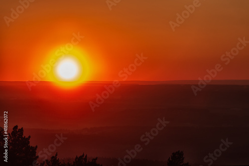 The bright sun is the eye of the horizon. Background sunset