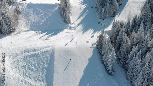 Aerial drone footage of skiers on Whistler Mountain, BC, at creekside on a sunny day. 4K 24FPS. photo