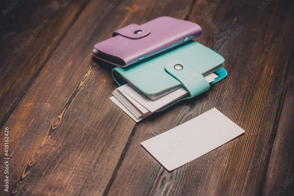 two business card holders on a wooden background cardboard paper wallet two business card holders on a wooden background cardboard paper wallet