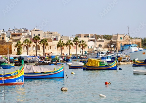 Marsaxlokk, Malta: Maltese boats – the Luzzu and the Dgħajsa - float in the harbor of Marsaxlokk, Malta. the fishing boats are decorated with the eye of Osiris to keep the fishers safe at sea. 