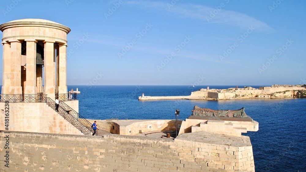 The Siege Bell War Memorial on the lower part of St. Christopher Bastion, facing the harbor and the town of Valletta, Malta. It features a rotunda with a bronze bell and a tribute to fallen soldier. 