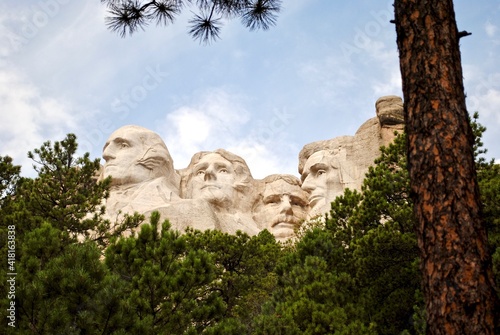 Unique perspective directly under the carving of Mount Rushmore. The Presidential Trail gives a close up view of the presidents in the Black Hills in Keystone, South Dakota, United States.  photo