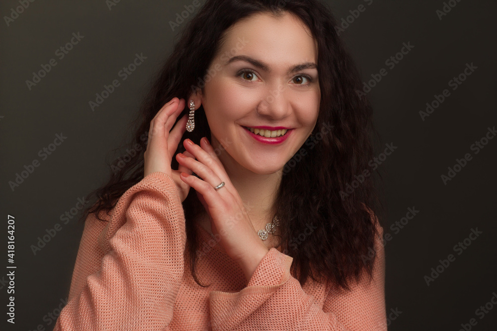 Studio portrait of a brunette in peach dress Studio portrait of a brunette in peach dress