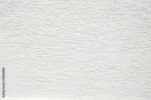 White facade wall texture rough stucco close up.