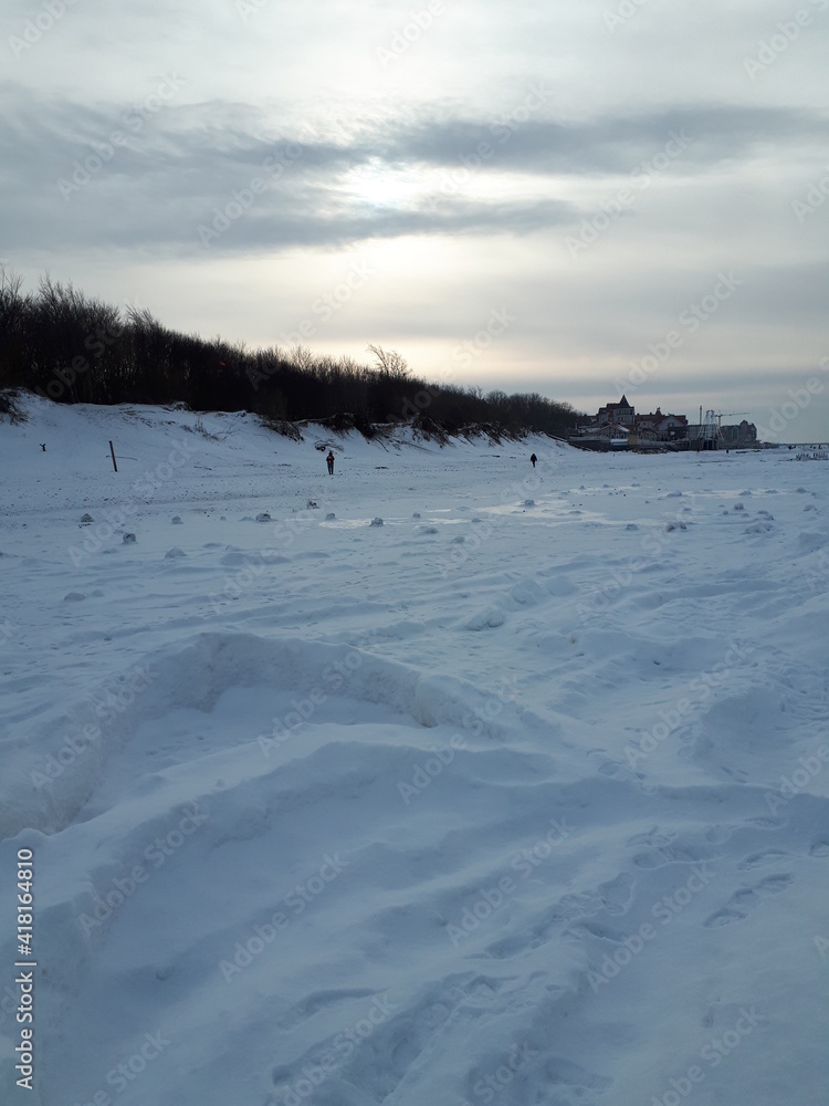 Winter on the Curonian Spit. Cold snow-covered beach