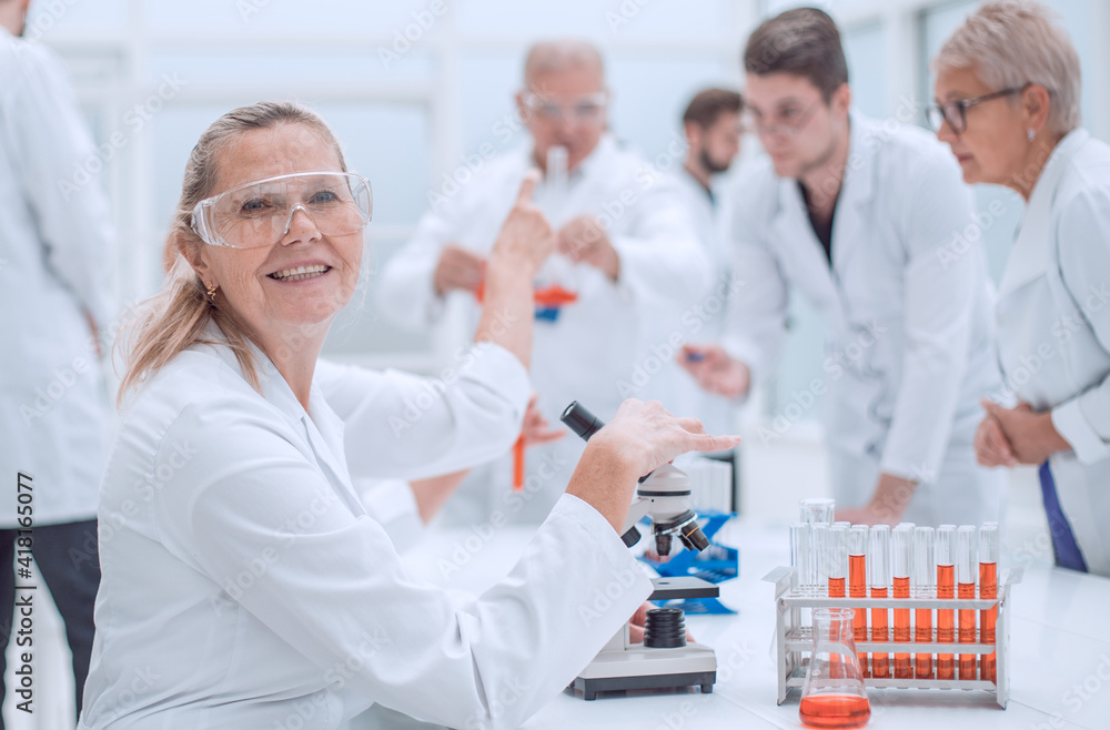 close up. senior female scientist sitting at a laboratory table. close up. senior female scientist sitting at a laboratory table.