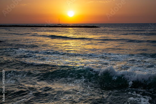 Sailing boat at sunset in orange tones over the Mediterranean sea in Tel Aviv  Israel