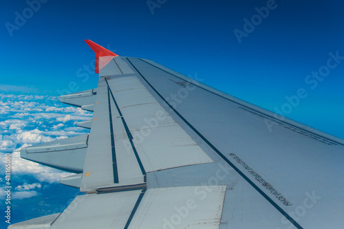 Airplane wing and clear sky.