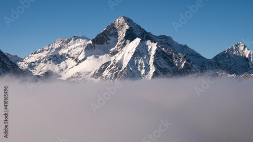 snow covered mountains, view from above the clouds. © Nico Vigouroux