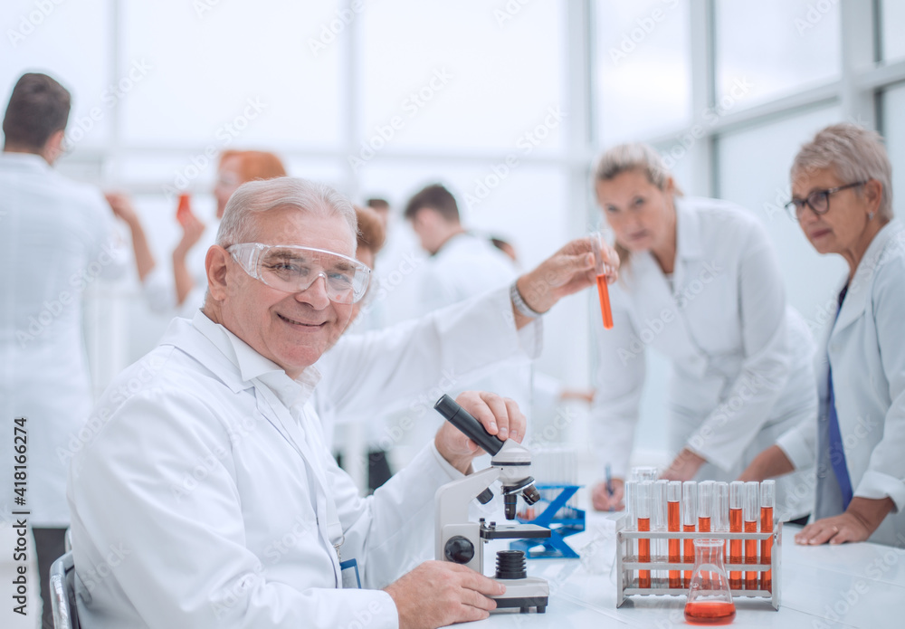 smiling scientist at the workplace in the laboratory. smiling scientist at the workplace in the laboratory.