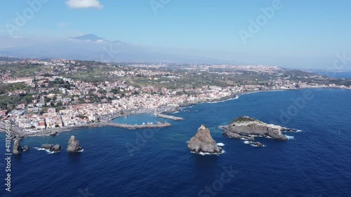 Drone flight view of Acitrezza bay with Etna volcano in background in Sicily Italy