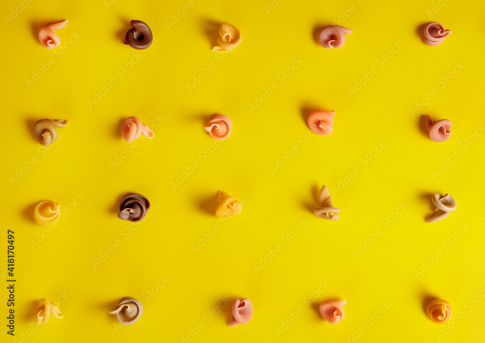 colored pasta on a yellow background. Italian pasta pattern colored pasta on a yellow background. Italian pasta pattern