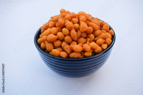 Indian famous namkeer snack Kara boondi or spicy salty boondi served in transparent bowl. Tea time snack fried chickpea floour or besan deep fried in oil. Tasty crunchy yummy homemade festival snack photo